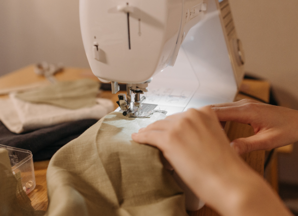 Hands sewing a garment